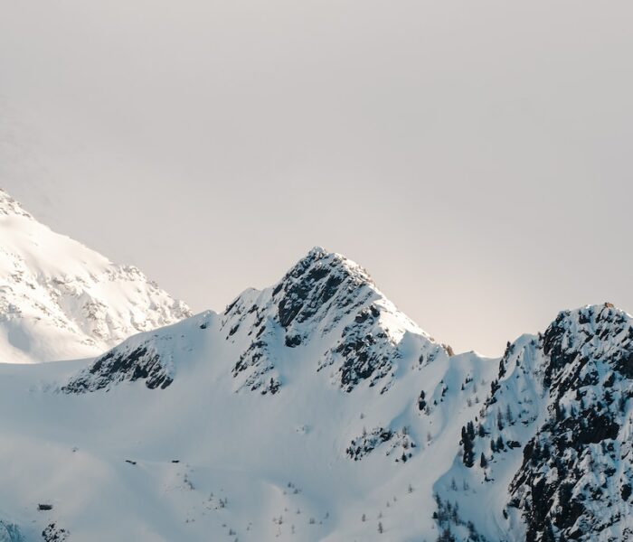 a mountain covered in snow with a sky background