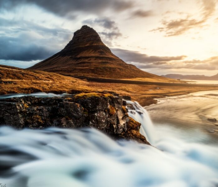 a mountain with a body of water in front of it