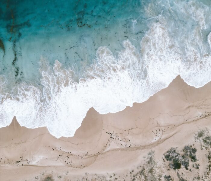 an aerial view of a sandy beach and ocean